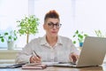 Portrait of mature woman working at home on computer laptop Royalty Free Stock Photo