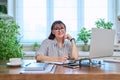 Portrait of mature woman working at home on computer laptop Royalty Free Stock Photo