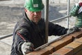 Portrait of measuring construction worker