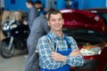 portrait mechanic holding wrench in garage