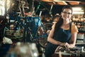 Portrait, mechanic and smile of woman in bicycle shop, repair store or cycling workshop. Face, bike technician and