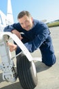 Portrait mechanic working on aircraft`s landing gear