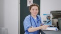 Portrait of medical assistant analyzing checkup papers at hospital reception desk Royalty Free Stock Photo