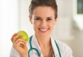 Portrait of medical doctor woman with apple