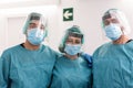 Portrait of medical doctors looking at camera with hospital corridor in background - Main focus on male surgeons Royalty Free Stock Photo