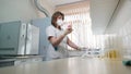 Portrait of medical laboratory technician in respirator and pipette with bulb