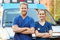 Portrait Of Medical Staff Standing In Front Of Ambulance