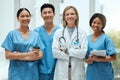 Portrait, medical and a woman doctor arms crossed, standing with her team in the hospital for healthcare. Leadership Royalty Free Stock Photo