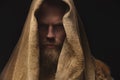 Portrait of a medieval bearded war monk dressed in animal skins and sacking. Low key. Focus on clothing. Atmospheric Royalty Free Stock Photo