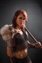 Portrait of a medieval, fantasy viking woman with an ax in her hands in the dark. Royalty Free Stock Photo