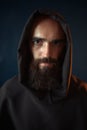 Portrait of medieval monk in black robe with hood Royalty Free Stock Photo