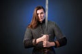 Portrait of a medieval warrior of the late Viking era and the beginning of the Crusades. Knight with long hair in chain mail