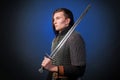 Portrait of a medieval warrior of the late Viking era and the beginning of the Crusades. Knight with long hair in chain mail Royalty Free Stock Photo