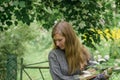 Portrait of a melancholy woman with long hair against a nature background Royalty Free Stock Photo