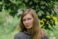 Portrait of a melancholy woman with long hair against a nature background Royalty Free Stock Photo