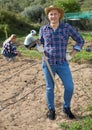 Man gardener with hoe at smallholding Royalty Free Stock Photo