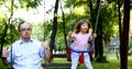 Portrait of man and girl with down syndrome swinging Royalty Free Stock Photo