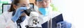 Concentrated lab workers in glasswares Royalty Free Stock Photo