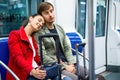 Portrait of metro passengers sitting in car seats and smiling