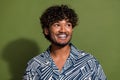 Portrait of mexican handsome guy with wavy hair cheerful smile looking empty space positive thoughts isolated on khaki Royalty Free Stock Photo