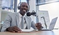 Portrait, microphone and man on laptop for radio, podcast or business influencer in studio, happy and excited. Face Royalty Free Stock Photo