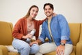 Portrait, microphone and podcast with a couple on a sofa in the living room of their home together. Smile, radio or