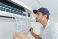 Portrait mid-adult male technician repairing air conditioner Royalty Free Stock Photo