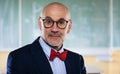 Portrait of mid aged math professor standing in front of blackboard at the classroom Royalty Free Stock Photo