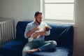 Caucasian father feeding newborn baby son daughter with milk Royalty Free Stock Photo