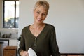 Portrait of middle age caucasian mother mixing batter in a bowl in the kitchen