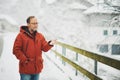 Portrait of middle age man, 55 - 60 years old, enjoying nice cold day, wearing red orange winter jacket