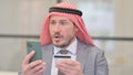 Portrait Middle Aged Arab Businessman with Online Payment Failure on Smartphone