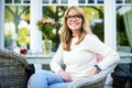 Happy mature woman relaxing at home in the backyard Royalty Free Stock Photo