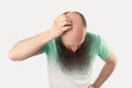 Portrait of middle aged bald man with long beard in light green t-shirt standing and showing his baldness on his head Royalty Free Stock Photo