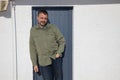 Portrait of middle aged beard Man smiling front home grey door Royalty Free Stock Photo