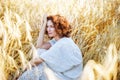 Middle aged beautiful smiling woman in wheat field