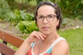 Portrait of a middle-aged brunette woman with eyeglasses, outdoor Royalty Free Stock Photo