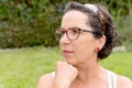 Portrait of a middle-aged brunette woman with eyeglasses, outdoor Royalty Free Stock Photo