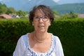 Portrait of a middle-aged brunette woman with eyeglasses, outdoor Royalty Free Stock Photo