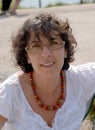 Portrait of a middle-aged brunette woman with eyeglasses, outdoor Royalty Free Stock Photo