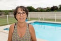 Portrait of a middle-aged brunette woman with eyeglasses, outdoor Royalty Free Stock Photo