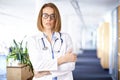 Portrait of middle aged female doctor standing in hospital corridor Royalty Free Stock Photo