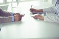 Portrait of middle aged female doctor using digital tablet while sitting at exam room and working Royalty Free Stock Photo