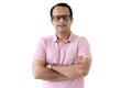 Portrait of a middle aged happy smiling Indian man in a pink T-shirt wearing glasses, standing with arms crossed isolated on white Royalty Free Stock Photo