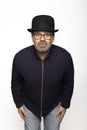 Portrait middle-aged man with glasses, bowler hat and round glasses, is leaning forward Royalty Free Stock Photo