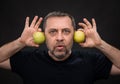 Middle-aged man with a green apples Royalty Free Stock Photo