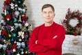 Portrait Middle-aged man posing against the backdrop of the New Year tree of Cain and Christmas decorations Royalty Free Stock Photo