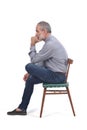 Portrait of middle aged man sitting on white Royalty Free Stock Photo