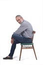 Portrait of middle aged man sitting on white Royalty Free Stock Photo