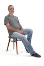 Portrait of middle aged man sitting on white Royalty Free Stock Photo